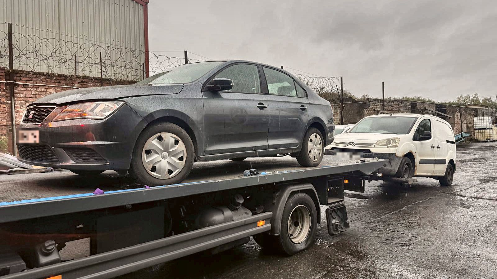 Carntyne recovery truck carrying a car with a van on the back